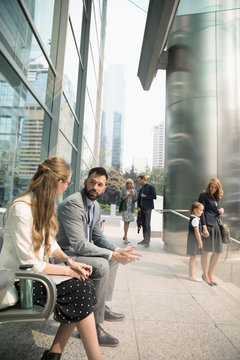 Business People Talking On Urban Bench