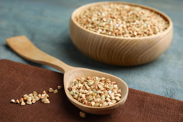 Uncooked green buckwheat grains on table, closeup