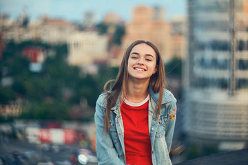 Lovely teen girl on cityscape background