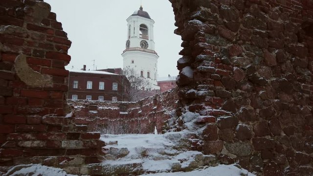 clock tower from the window of the destroyed Church, Vyborg, Russia, winter