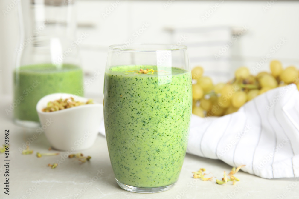 Sticker Green buckwheat smoothie on light grey marble table