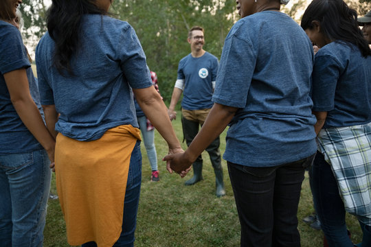 Volunteers holding hands in circle