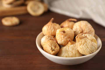 Tasty dried figs on wooden table, closeup. Space for text
