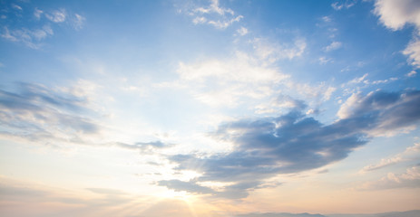 Blue sky clouds background. Beautiful landscape with clouds and orange sun on sky