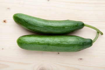 Two Cucumbers on a wooden background.