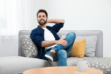 Young man relaxing on couch at home