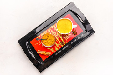 Traditional Indian masala tea chai with spices, cinnamon, anise and cardamom in a white cup on an...