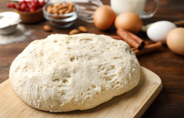 Board with wheat dough for pastries, closeup