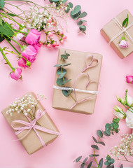 Craft paper wrapping gift boxes on pink background