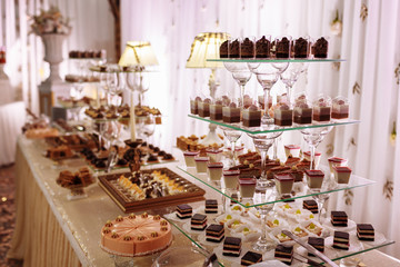 Sweet table for wedding. Candy bar with a lot of different candies and sweet chokolate cakes