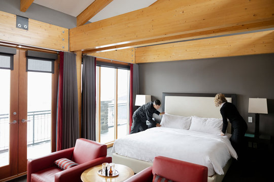 Hotel Staff Maids Making Bed In Luxury Hotel Room