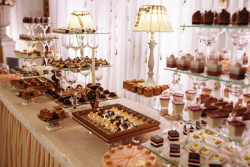 Sweet table for wedding. Candy bar with a lot of different candies and sweet chokolate cakes