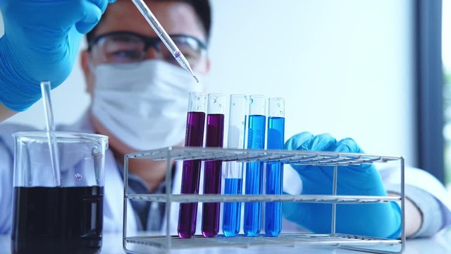Scientist with equipment holding tools during scientific experiment science concept