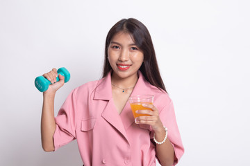 Young Asian woman with dumbbell drink orange juice.