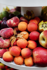 Naklejka na ściany i meble plate with various fresh fruits, strawberries, apples, peaches and kiwi. fruit background