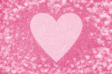 Shiny pink background with glitter effect and heart shaped bokeh. Big pale heart in the center