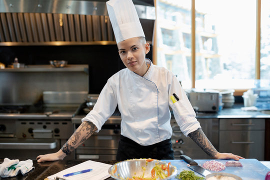 Portrait Confident Female Prep Cook Working In Restaurant Kitchen