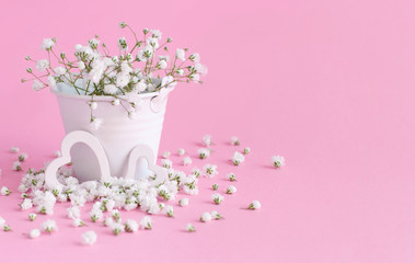 Small white flowers and hearts on a lavender background