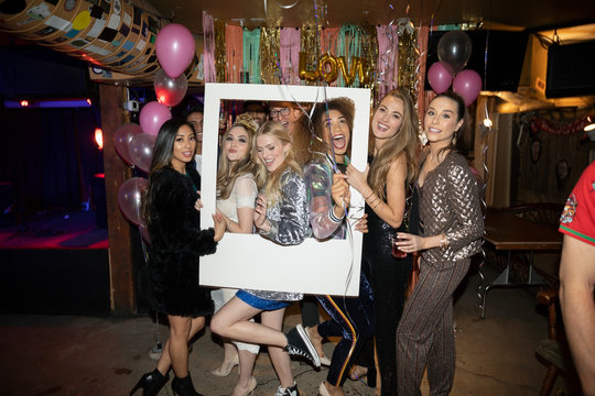 Portrait Playful Women Friends Posing For Photo Booth At Party