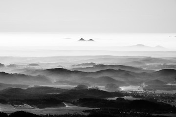 Bezdez twin mountains rising from the mist. Weather temperature inversion, Czech Republic