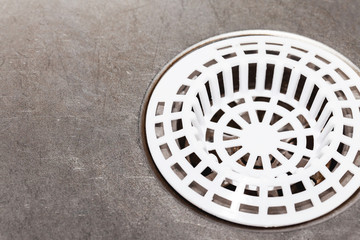 Metal kitchen sink. Plastic white sieve closeup empty copy space background.