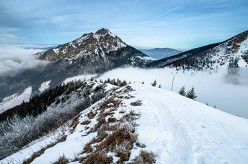 Fototapeta premium Blue frozen winter mountains. Rocky Hill in background