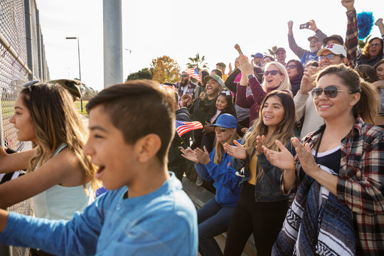 Excited Baseball Fans Cheering In Bleachers