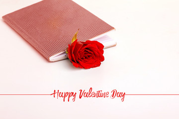 book with a red rose flower on it. White background. Valentine day concept