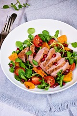 Duck breast fillets steak salad with roasted pumpkin, tomatoes and pomegranate seeds