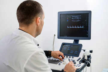 Fototapeta na wymiar The doctor conducts an ultrasound examination.. Ultrasound examination of the thyroid gland