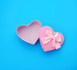 open empty cardboard box in the form of a heart on a light blue background