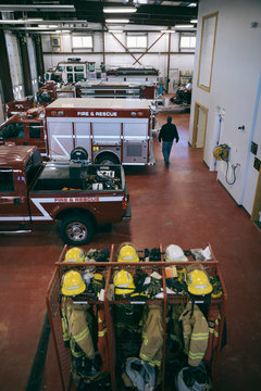 Fire Protection Suits And Fire Engines And Trucks In Fire Station