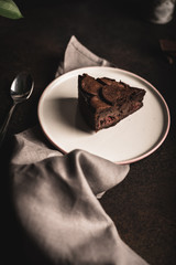 Piece of chocolate tart with mousse filling and cherries moody foodphotography