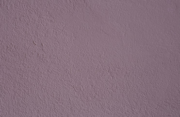 Beautiful  purple textured stucco on the wall.