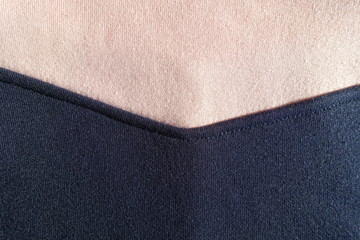 Angled seam between navy blue and pink jersey fabric