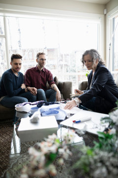 Wedding consultant meeting with gay male couple
