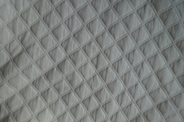 View of white quilted fabric from above