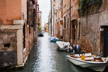 Fototapeta na wymiar canal, motor boats near ancient buildings in Venice, Italy