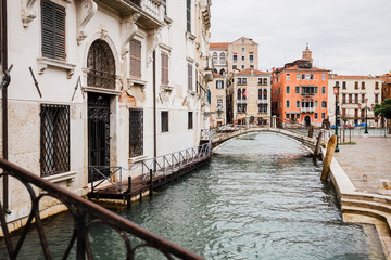  bridge above canal near ancient buildings in Venice, Italy