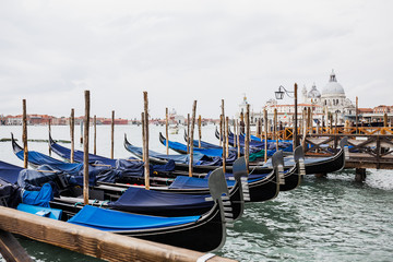 Fototapeta na wymiar river, blue gondolas and Santa Maria della Salute in Venice, Italy