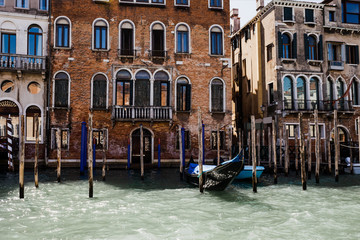 Fototapeta na wymiar canal with gondola and ancient building in Venice, Italy