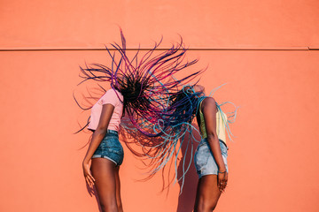 two women sisters dancing moving hair outdoor