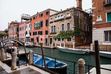 Fototapeta na wymiar canal, motor boats and ancient buildings in Venice, Italy