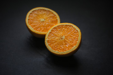 Culinary Sliced Orange on Black Background Natural Light