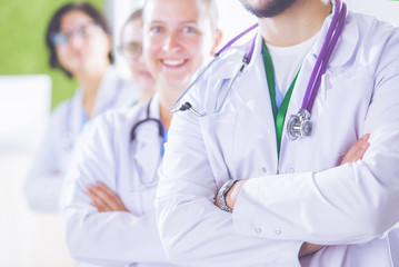 Fototapeta premium Happy medical team comprising male and female doctors smiling broadly and giving a thumbs up of success and hope