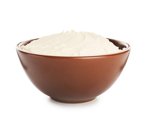 Bowl with tasty cream cheese on white background