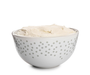 Bowl with tasty cream cheese on white background