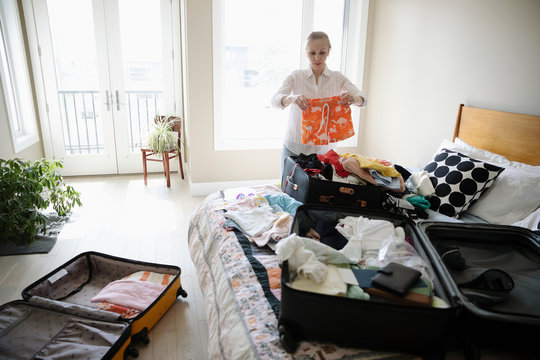 Woman packing suitcases for vacation