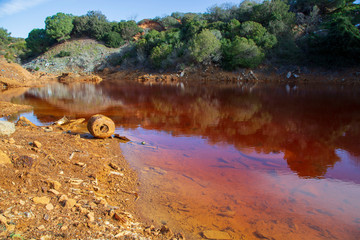 Pollution in the red lake 'Le Conche' on Elba island. Italy