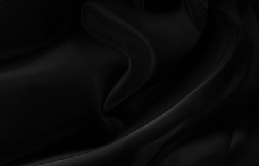 Black gray satin dark fabric texture luxurious shiny that is abstract silk cloth background with patterns soft waves blur beautiful.